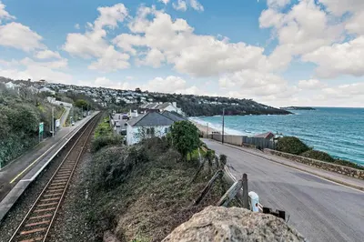an empty road next to the ocean with a house at 2 Bed in Carbis Bay oc-t27418 in Carbis Bay