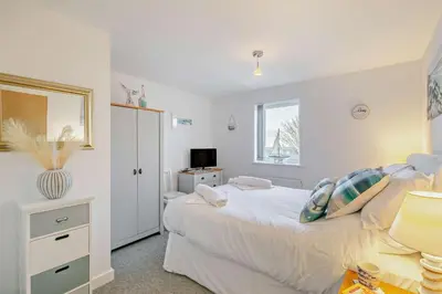 a bedroom with a bed and a desk with a television at 2 Bed in Carbis Bay oc-t27418 in Carbis Bay