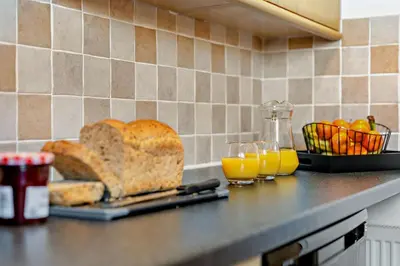 a counter top with bread and glasses of orange juice at 2 Bed in Carbis Bay oc-t27418 in Carbis Bay