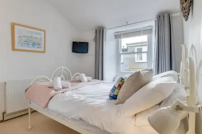 a white bed in a room with a window at 2 Bed in St Ives oc-tee009 in St Ives