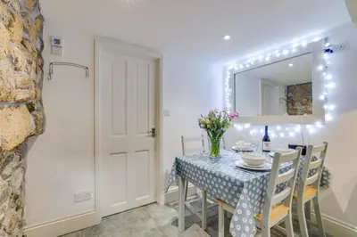 a dining room with a table and a mirror at 2 Bed in St Ives oc-tee009 in St Ives
