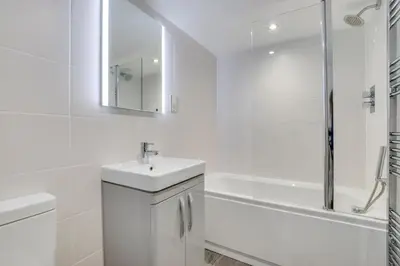 a white bathroom with a sink and a shower at 2 Bed in St Ives oc-tee009 in St Ives