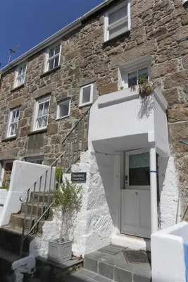a stone building with a white door and stairs at 2 Bed in St Ives oc-tee009 in St Ives