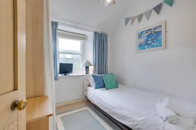 a small bedroom with a bed and a window at 2 Bed in St Ives oc-tee009 in St Ives