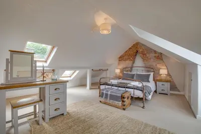 a bedroom with a bed and a desk in a attic at 3 Bed in St Ives oc-twp21 in St Ives