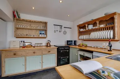 a kitchen with wooden cabinets and a stove top oven at 3 Bed in St Ives oc-twp21 in St Ives