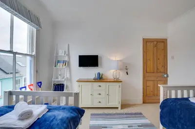 a bedroom with two beds and a tv on a wall at 3 Bed in St Ives oc-twp21 in St Ives