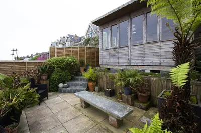 a garden with a bench and plants in front of a building at 3 Bed in St Ives oc-twp21 in St Ives