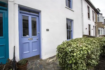 a blue door on a white house with a hedge at 3 Bed in St Ives oc-twp21 in St Ives