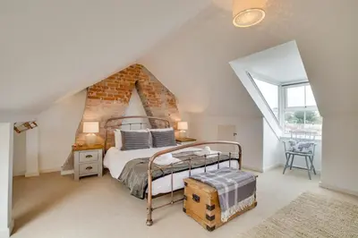a bedroom with a metal bed in a attic at 3 Bed in St Ives oc-twp21 in St Ives