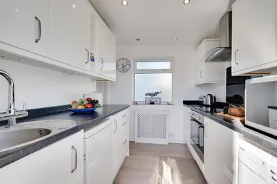 a kitchen with white cabinets and a sink at 3 Bed in St Ives oc-twp32 in St Ives