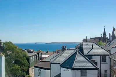 a group of buildings with the ocean in the background at 3 Bed in St Ives oc-twp32 in St Ives