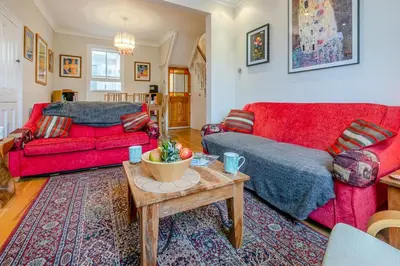 a living room with two red couches and a table at 3 Bed in St Ives oc-twtc11 in St Ives