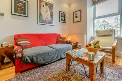 a living room with a red couch and a table at 3 Bed in St Ives oc-twtc11 in St Ives