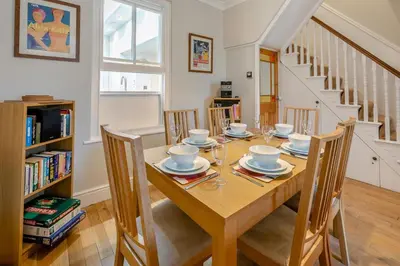 a dining room with a wooden table and chairs at 3 Bed in St Ives oc-twtc11 in St Ives
