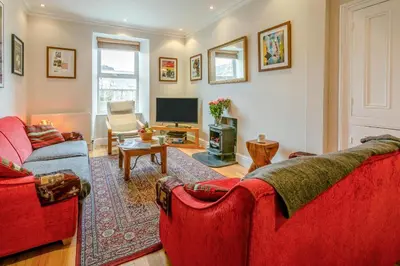 a living room with two red couches and a television at 3 Bed in St Ives oc-twtc11 in St Ives