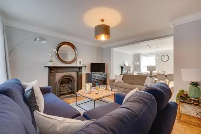 a living room with a blue couch and a fireplace at 4 Bed in St. Ives oc-uppcr in St Ives