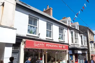 a shop with a red awning on a street at 2 Bed in St. Ives oc-upper4 in St Ives