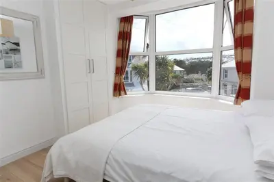 a bedroom with a white bed and a large window at 2 Bed in St Ives oc-ven10a in St Ives