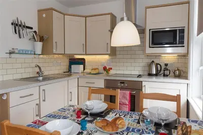 a kitchen with a table and chairs and a kitchen with a sink at 2 Bed in St Ives oc-ven10a in St Ives