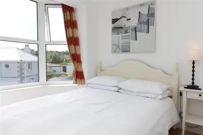 a white bedroom with a bed and a window at 2 Bed in St Ives oc-ven10a in St Ives