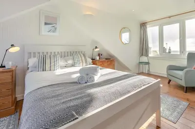 a bedroom with a large bed with two stuffed animals on it at 3 Bed in St Ives oc-vgn28 in St Ives