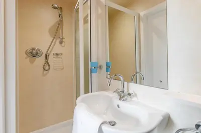 a white bathroom with a sink and a shower at 3 Bed in St Ives oc-vgn28 in St Ives