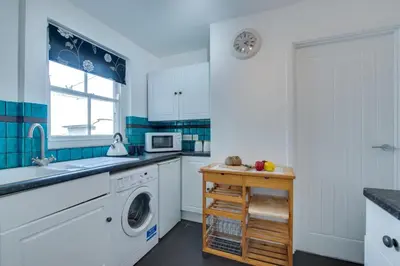 a kitchen with a washing machine and a sink at 3 Bed in St. Ives oc-virg14 in St Ives