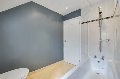 a bathroom with a white tub and a toilet at 3 Bed in St. Ives oc-virg14 in St Ives