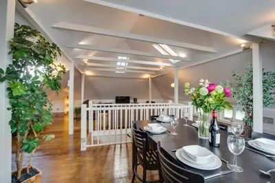 a dining room with a table with chairs and flowers at 2 Bed in St. Ives oc-wesh4 in St Ives