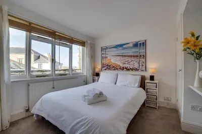a bedroom with a white bed and a large window at 3 Bed in St Ives oc-weshs in St Ives