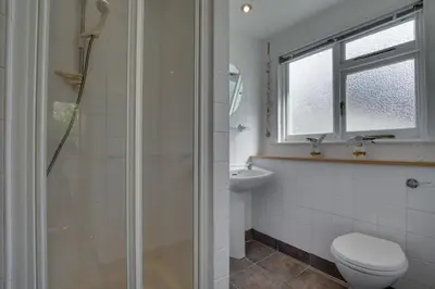 a bathroom with a shower and a toilet and a sink at 3 Bed in St Ives oc-weshs in St Ives