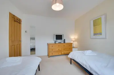 a bedroom with two beds and a tv on a dresser at 2 Bed in St Ives oc-wyp026 in St Ives