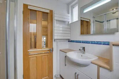 a bathroom with a sink and a wooden door at 2 Bed in St Ives oc-wyp026 in St Ives