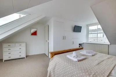 a white bedroom with a bed and a window at 2 Bed in St Ives oc-wyp026 in St Ives
