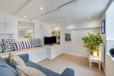 a living room with a blue couch and a tv at 2 Bed in St Ives oc-wyp026 in St Ives
