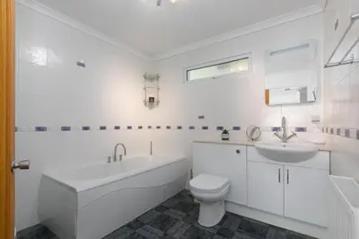 a white bathroom with a tub sink and a toilet at Ocean Air in Carbis Bay