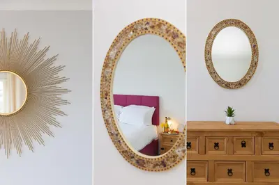 a bedroom with a mirror and a wooden dresser at Ocean Air in Carbis Bay