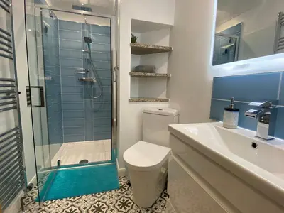 a bathroom with a shower and a toilet and a sink at Ashlea in Launceston