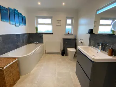 a bathroom with a tub and a sink and a toilet at Ashlea in Launceston