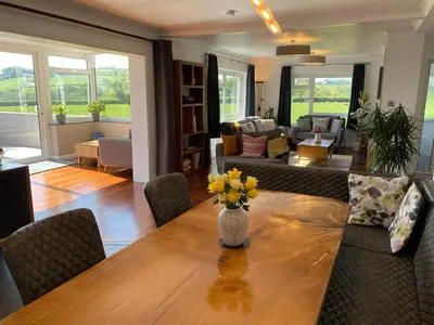 a living room with a table with flowers on it at Ashlea in Launceston