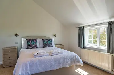 a bedroom with a bed with two towels on it at Finest Retreats - Trethew Cottage in Carnbrea