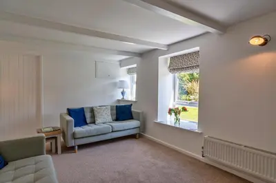 a living room with a couch and a window at Finest Retreats - Trethew Cottage in Carnbrea