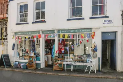 a store on a street with flags in front of it at 17 River Banks in Liskeard