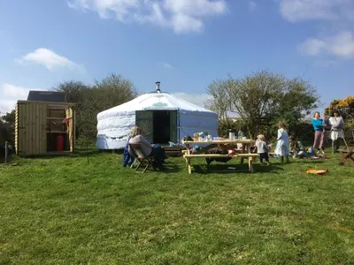 a group of people standing in front of a yurt at Higher Trenear Farm Yurts in Helston