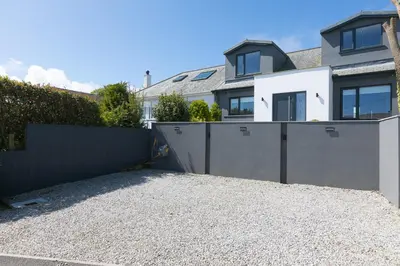 a house with a fence and a driveway at Willows in St Ives