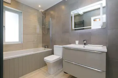 a bathroom with a toilet and a sink and a tub at Willows in St Ives