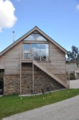a house with a staircase on the side of it at Fernsplatt Farm Lodge in Truro