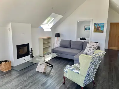 a living room with a couch and a table at Fernsplatt Farm Lodge in Truro