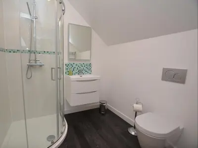 a bathroom with a shower and a toilet and a sink at Fernsplatt Farm Lodge in Truro